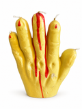 Bougie Halloween jaune en forme de main avec cinq mèches et détails rouges effet faux sang